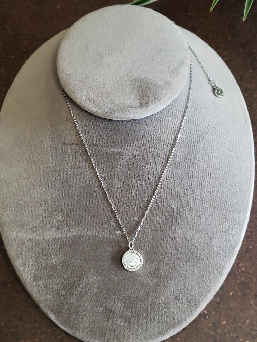 MICHAEL KORS MOTHER OF PEARL SILVER TONE CRYSTAL LOGO NECKLACE. Chain Length 16"